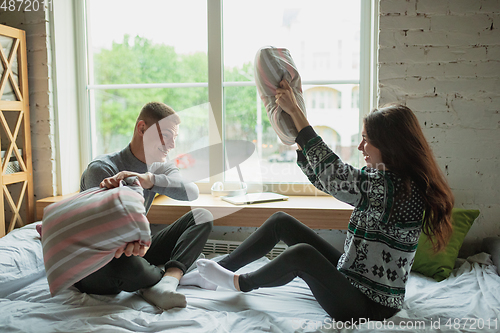 Image of Quarantine lockdown, stay home concept - young beautiful caucasian couple enjoying new lifestyle during coronavirus worldwide health emergency