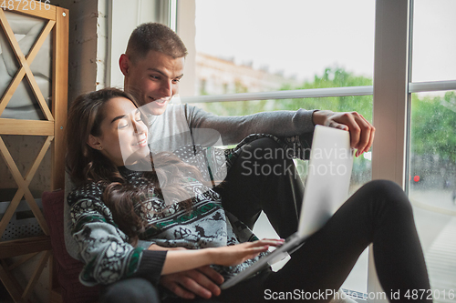 Image of Quarantine lockdown, stay home concept - young beautiful caucasian couple enjoying new lifestyle during coronavirus worldwide health emergency