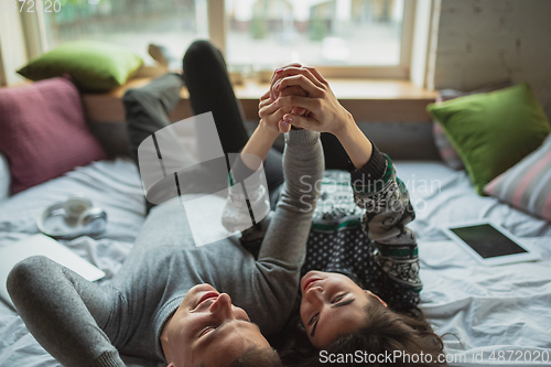 Image of Quarantine lockdown, stay home concept - young beautiful caucasian couple enjoying new lifestyle during coronavirus worldwide health emergency