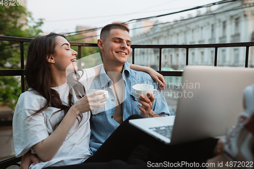 Image of Quarantine lockdown, stay home concept - young beautiful caucasian couple enjoying new lifestyle during coronavirus worldwide health emergency