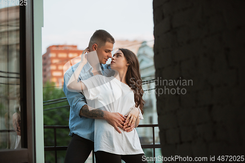 Image of Quarantine lockdown, stay home concept - young beautiful caucasian couple enjoying new lifestyle during coronavirus worldwide health emergency