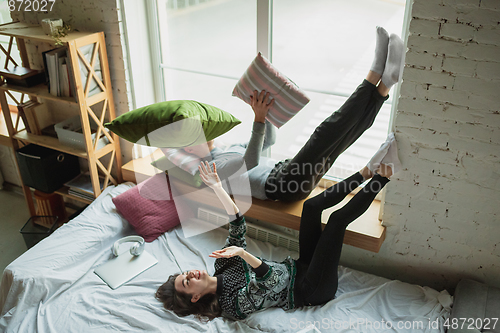 Image of Quarantine lockdown, stay home concept - young beautiful caucasian couple enjoying new lifestyle during coronavirus worldwide health emergency