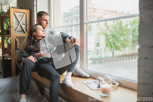 Image of Quarantine lockdown, stay home concept - young beautiful caucasian couple enjoying new lifestyle during coronavirus worldwide health emergency