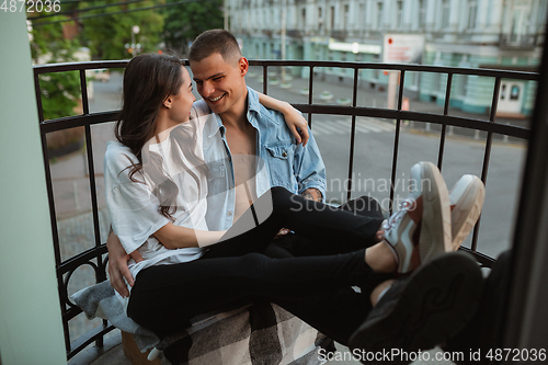 Image of Quarantine lockdown, stay home concept - young beautiful caucasian couple enjoying new lifestyle during coronavirus worldwide health emergency