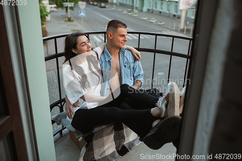 Image of Quarantine lockdown, stay home concept - young beautiful caucasian couple enjoying new lifestyle during coronavirus worldwide health emergency