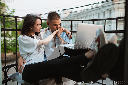 Image of Quarantine lockdown, stay home concept - young beautiful caucasian couple enjoying new lifestyle during coronavirus worldwide health emergency