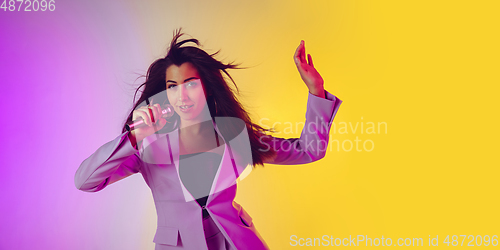 Image of Caucasian female singer portrait isolated on gradient studio background in neon light, flyer with copyspace for ad