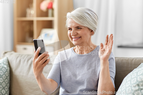 Image of senior woman having video call on smartphone