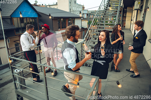 Image of Group of young caucasian people celebrating, look happy, have corporate party at office or bar