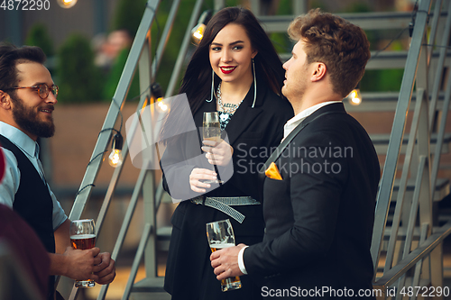 Image of Group of young caucasian people celebrating, look happy, have corporate party at office or bar