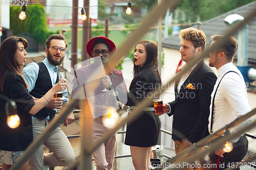 Image of Multiethnic group of people celebrating, look happy, have corporate party at office or bar