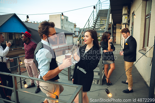 Image of Group of young caucasian people celebrating, look happy, have corporate party at office or bar