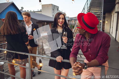 Image of Group of young people celebrating, look happy, have corporate party at office or bar