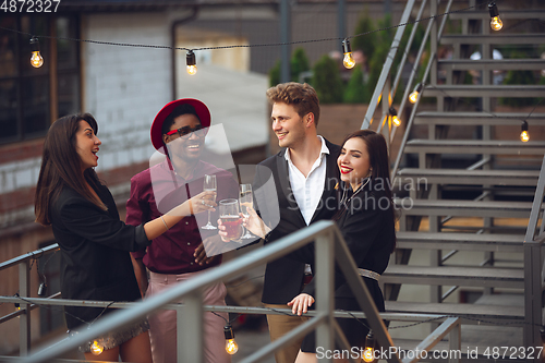 Image of Multiethnic group of people celebrating, look happy, have corporate party at office or bar