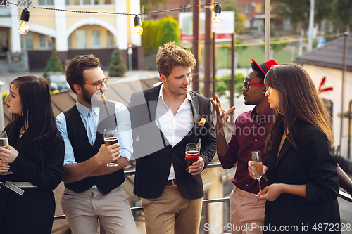 Image of Multiethnic group of people celebrating, look happy, have corporate party at office or bar