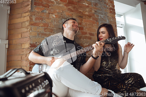 Image of Caucasian musicians during online concert at home insulated and quarantined, cheerful and happy