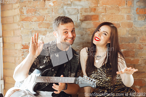 Image of Caucasian musicians preparing for concert at home insulated and quarantined, greeting audience before the start