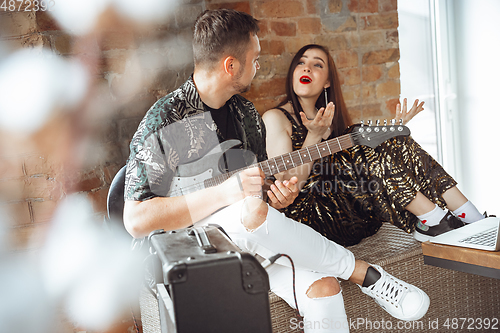 Image of Caucasian musicians during online concert at home insulated and quarantined, cheerful and happy, impressive improvising