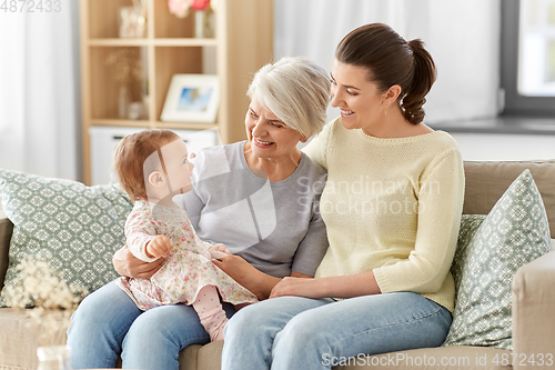 Image of mother, daughter and grandmother on sofa at home