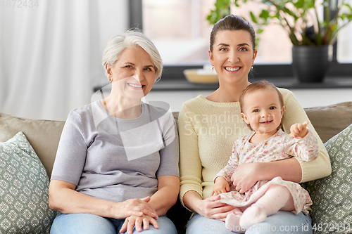 Image of mother, daughter and grandmother on sofa at home