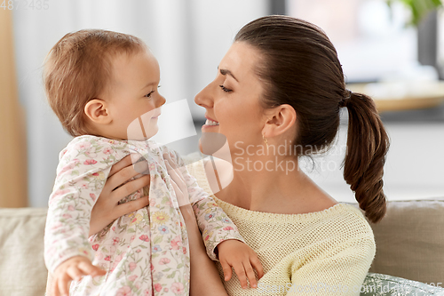 Image of happy mother with little baby daughter at home