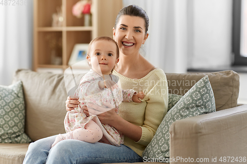 Image of happy mother with little baby daughter at home