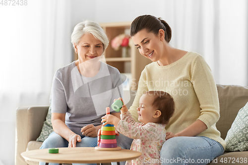 Image of mother, baby daughter and granny playing at home