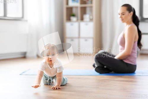 Image of happy mother with little baby at home