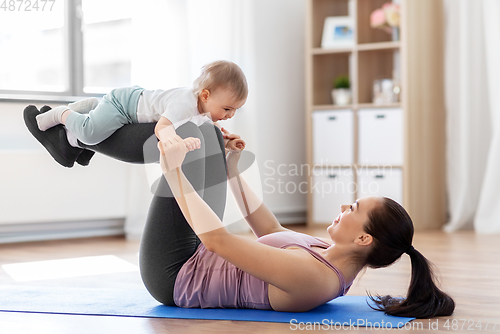 Image of happy mother with little baby exercising at home