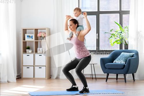 Image of happy mother with little baby exercising at home