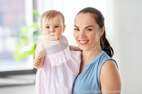 Image of happy mother with little baby daughter at home