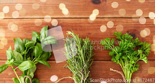 Image of greens, spices or medicinal herbs on wooden boards