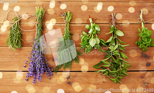 Image of greens, spices or medicinal herbs on wood