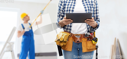 Image of woman or builder with tablet pc and working tools