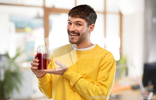 Image of happy man with juice in plastic cup at office