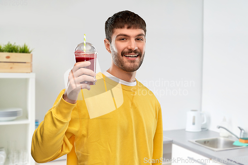 Image of happy man with tomato juice in takeaway cup