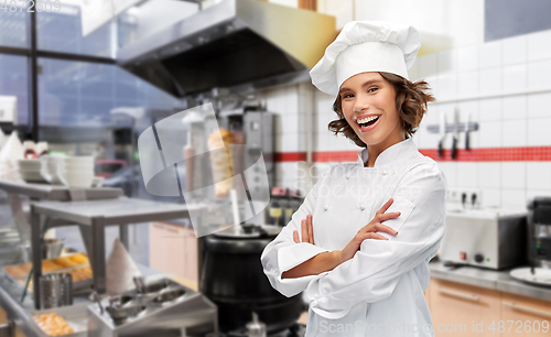 Image of happy female chef with crossed arms at kebab shop