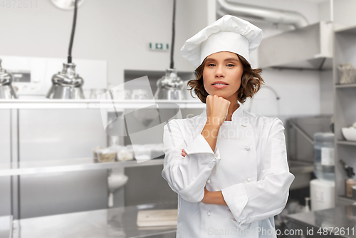 Image of female chef in toque thinking