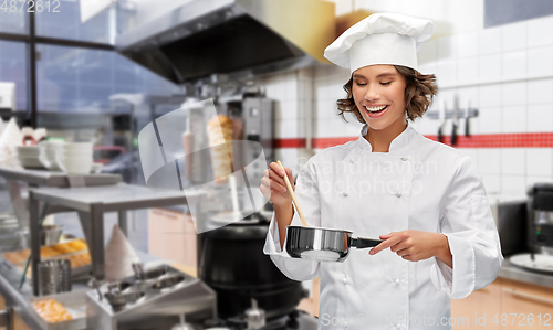 Image of smiling female chef with saucepan at kebab shop