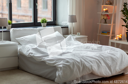 Image of cozy bedroom with white linen on bed