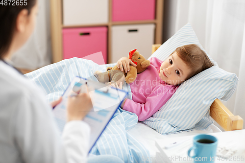 Image of doctor with clipboard and sick girl in bed at home