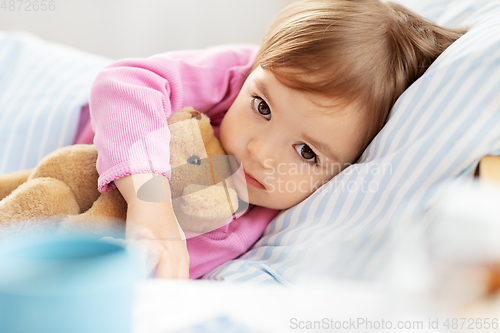 Image of little girl lying in bed at home