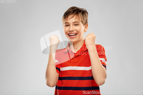 Image of portrait of happy smiling boy celebrating success