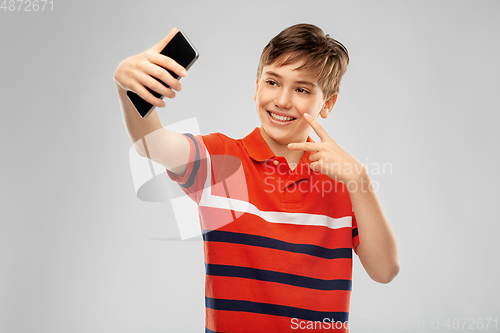 Image of happy smiling boy taking selfie with smartphone