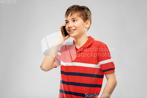 Image of happy smiling boy calling on smartphone