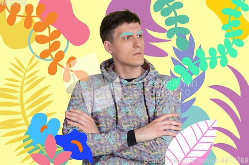 Image of Portrait of a young man with freaky appearance, look and bright colorful painted design