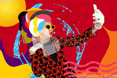 Image of Portrait of a young woman with freaky appearance, look and bright colorful painted design