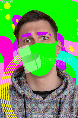 Image of Portrait of a young man with freaky appearance, look and bright colorful painted design