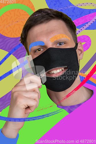 Image of Portrait of a young man with freaky appearance, look and bright colorful painted design