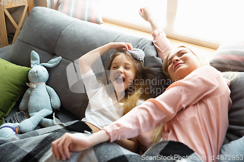 Image of Mother and daughter, sisters have quite, beauty and fun day together at home. Comfort and togetherness. Waking up in bedroom, good morning.